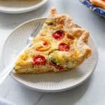 A slice of zucchini quiche on a plate.