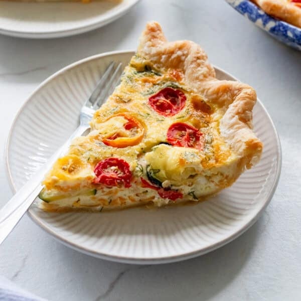 A slice of zucchini quiche on a plate.