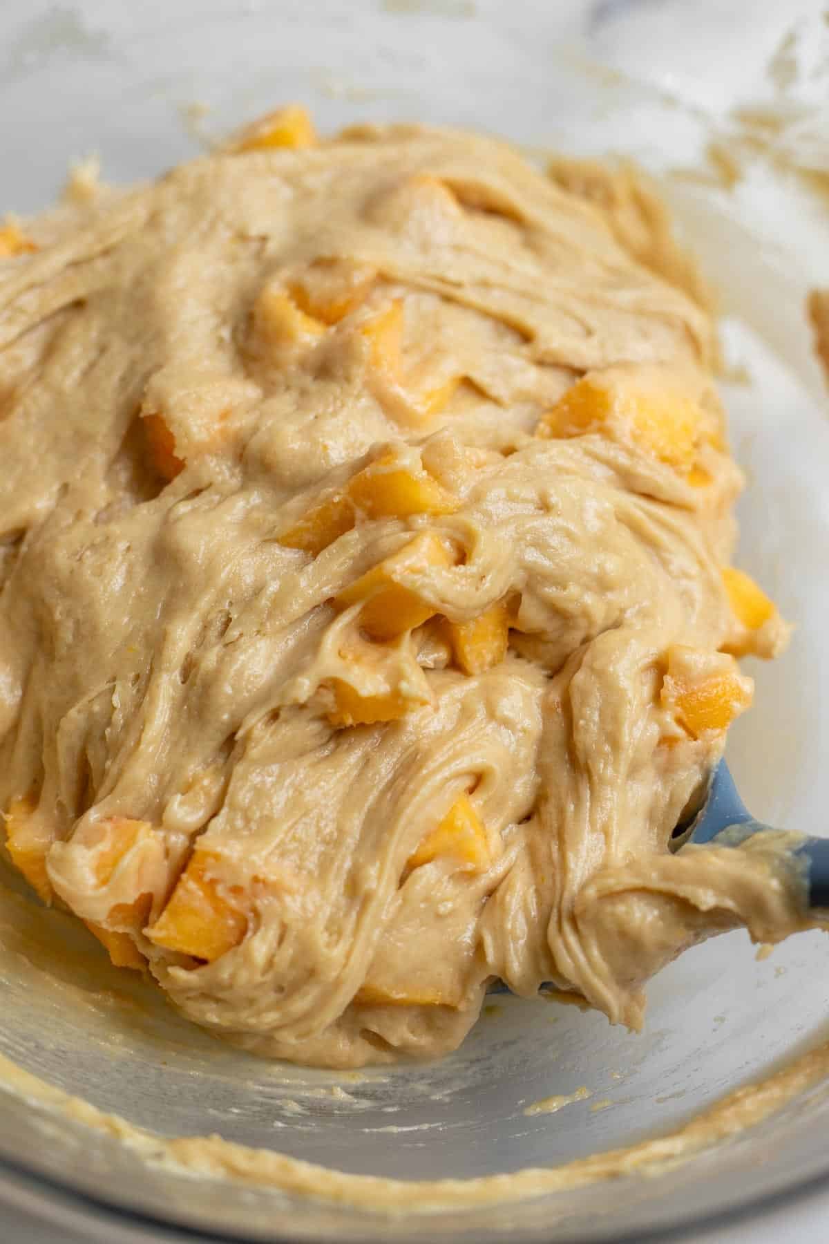 Diced peaches folded into a batter.