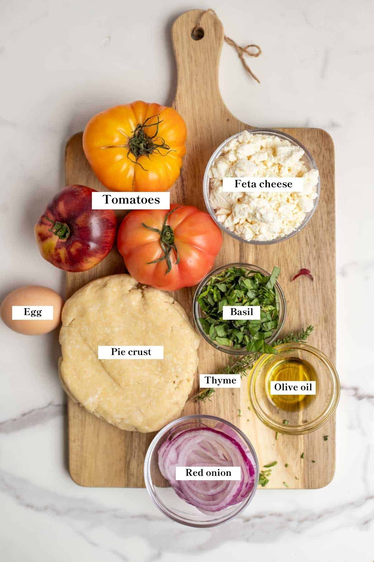 Ingredients for tomato galette on a cutting board.