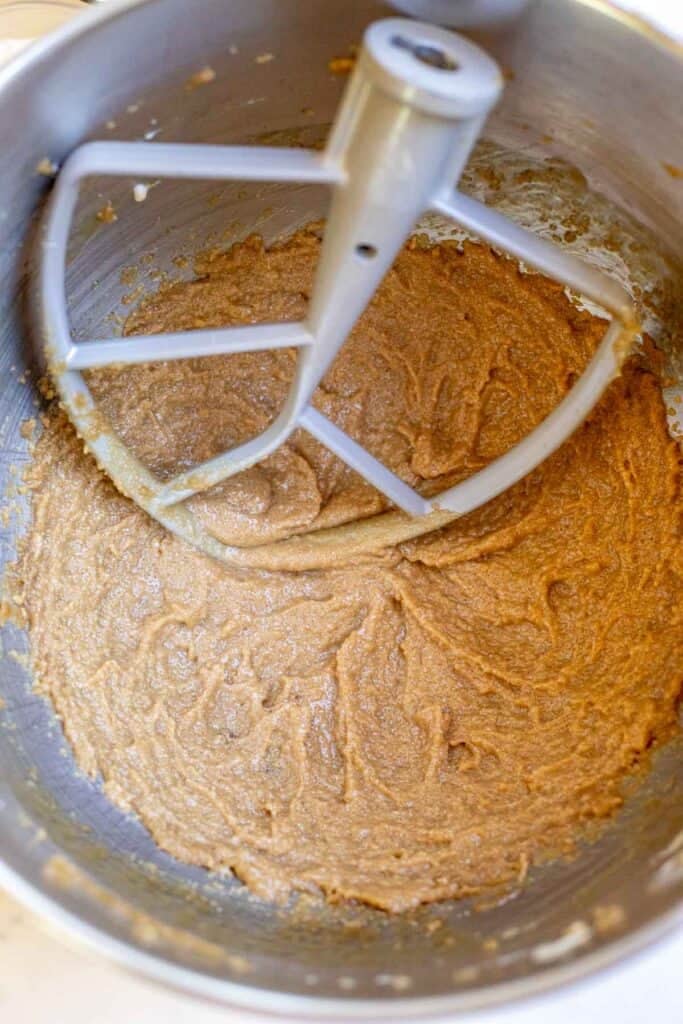 Butter and brown sugar mixed together in a stand mixer bowl with a paddle attachment.