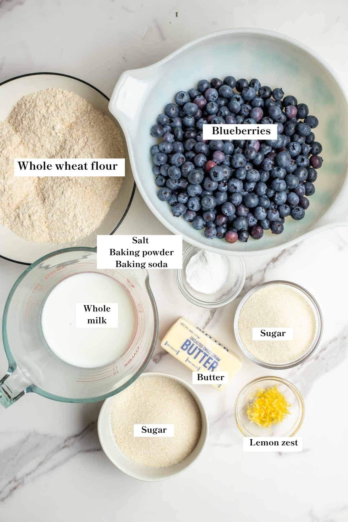 Ingredients for whole wheat blueberry cobbler in bowls on a counter.