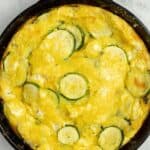 baked zucchini frittata in a cast iron skillet.