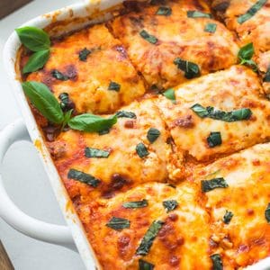 A zucchini lasagna sliced in a casserole dish.