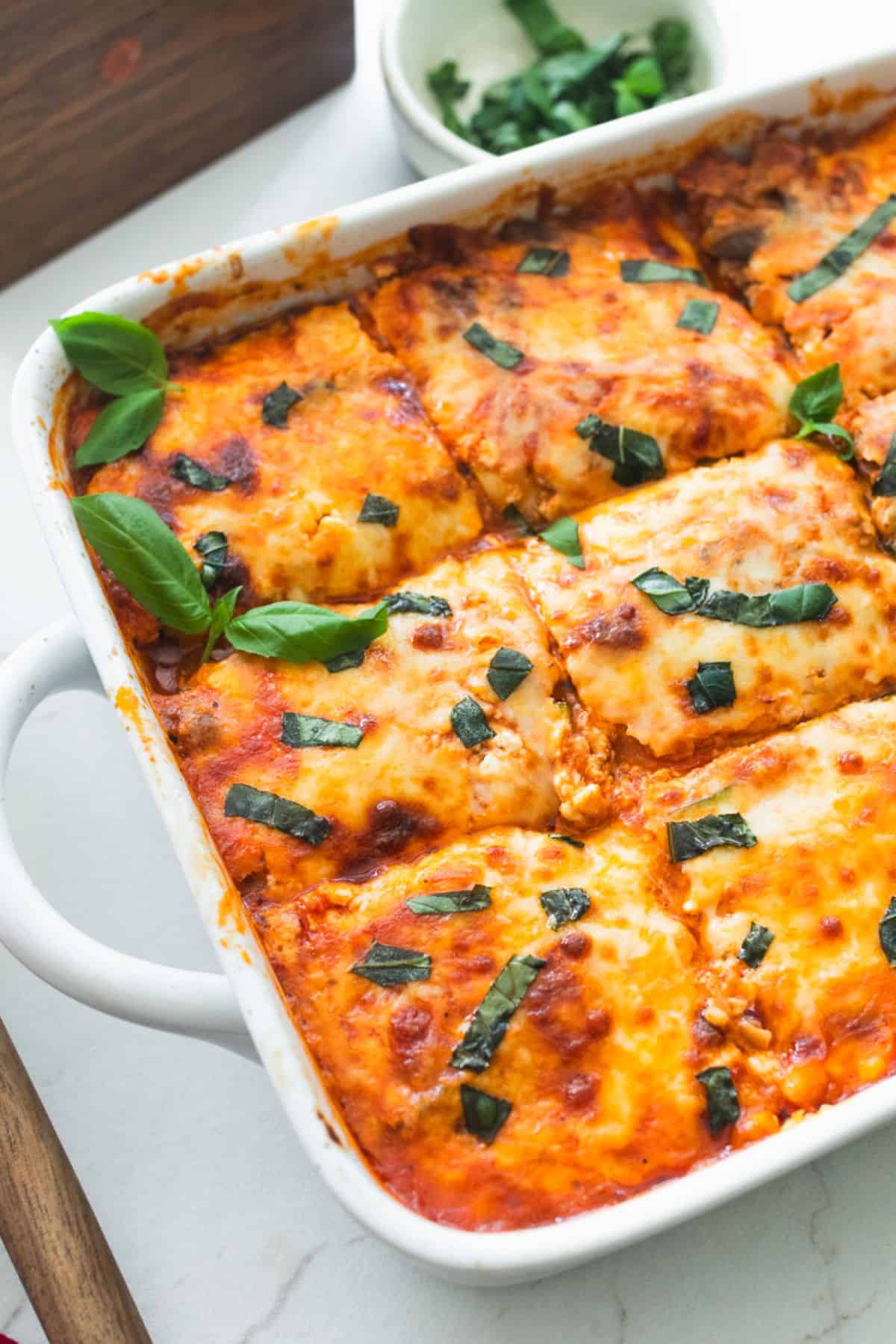 A zucchini lasagna sliced in a casserole dish.