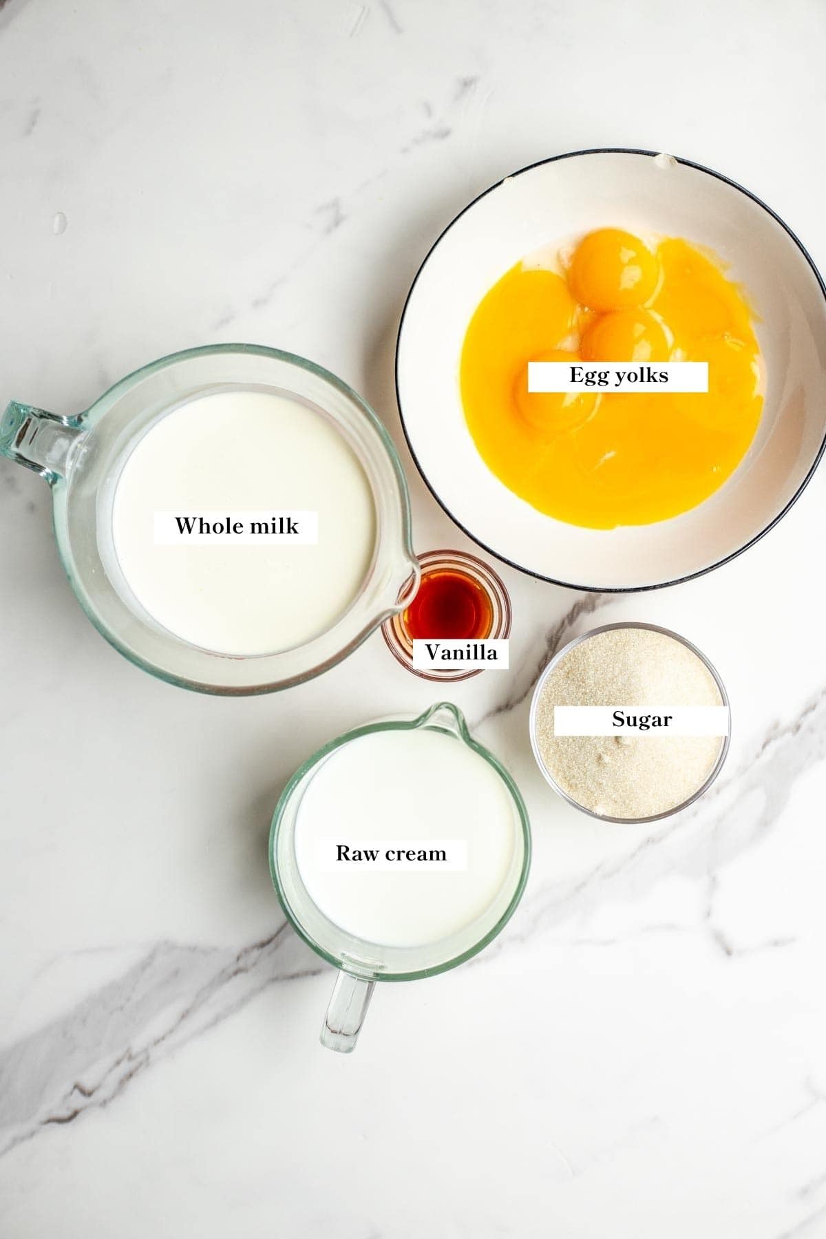 Ingredients for old fashioned vanilla ice cream in bowls on a counter.