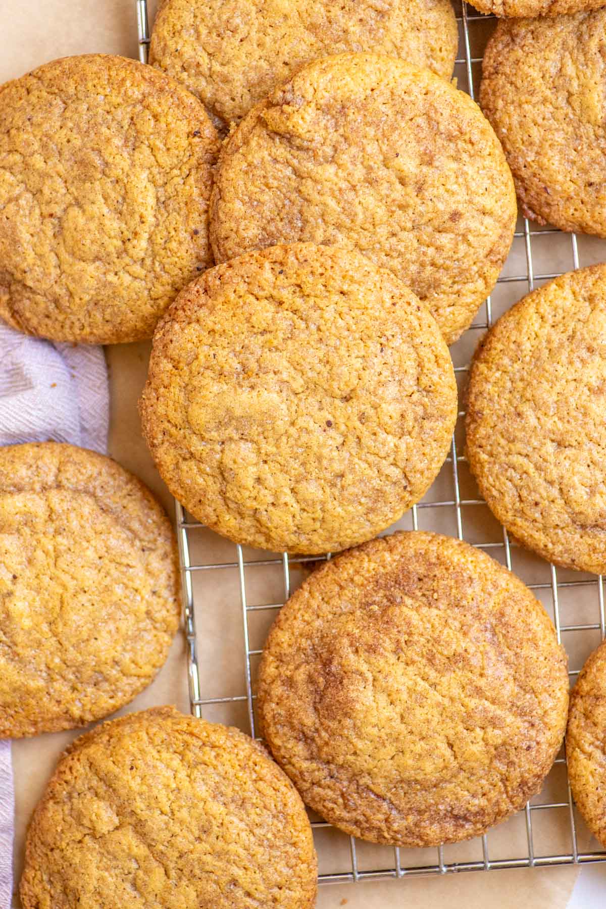 Sourdough pumpkin cookies cooling on a wire rack.