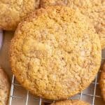 Sourdough pumpkin cookies stacked on a wire rack.