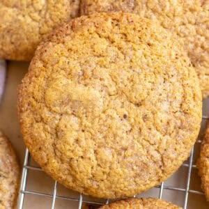 Sourdough pumpkin cookies stacked on a wire rack.
