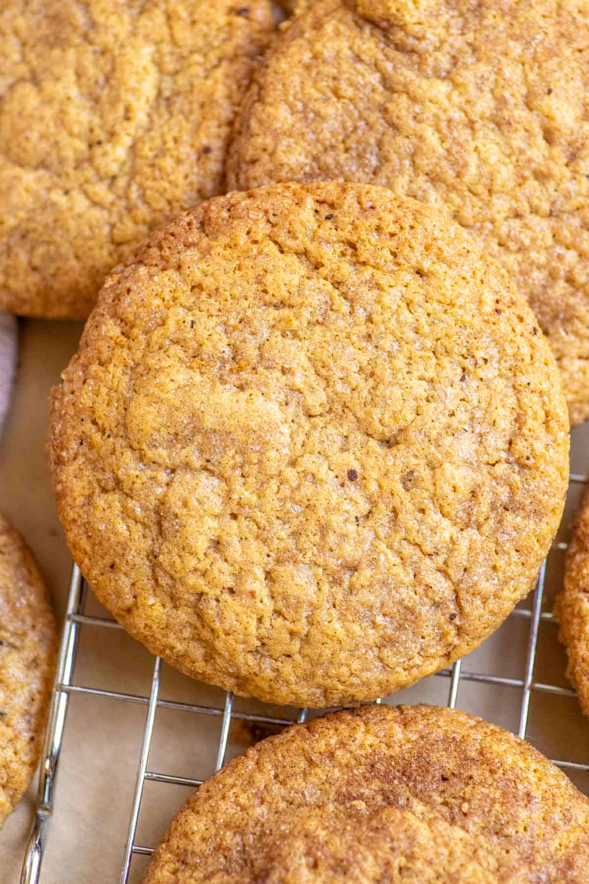 Sourdough pumpkin cookies stacked on a wire rack.