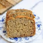two slices of sourdough banana bread on a blue dessert plate.