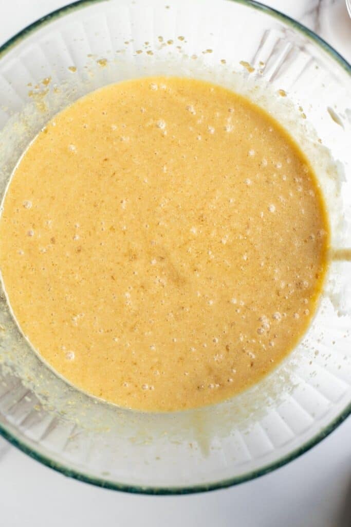 mashed bananas, eggs, and sourdough discard added to a glass bowl. 