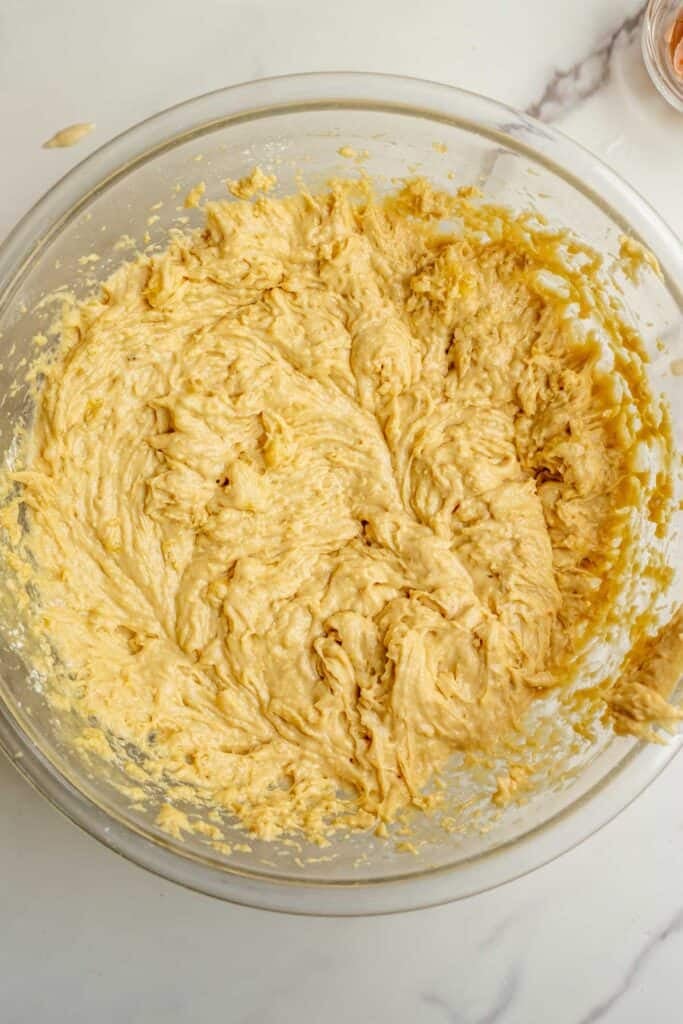 sourdough banana bread batter in a glass bowl on the counter.